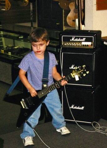 Michael Chandler as a kid, playing guitar in his dad's pawn shop